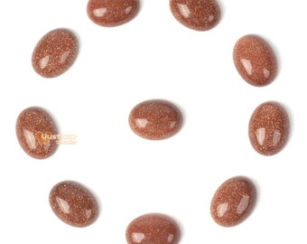 Puede incluir: Diez cabujones ovalados de arenisca marrón, cada uno con una superficie lisa y pulida. Las piedras están dispuestas en círculo sobre un fondo blanco.