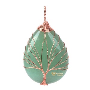 May include: A green aventurine stone pendant with a copper wire tree of life design. The pendant is shaped like a teardrop and has a copper wire loop at the top for hanging.