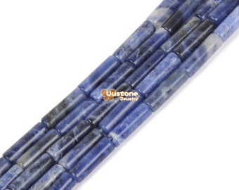 May include: Close-up of strands of sodalite gemstone beads. The beads are cylindrical, with a mix of deep blue, light blue, and gray hues. The beads are strung together, showcasing their natural variations and textures. The Uustone Jewelry logo is visible.