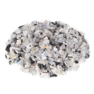 May include: A pile of white and black moonstone chips. The chips are smooth and have an iridescent sheen.