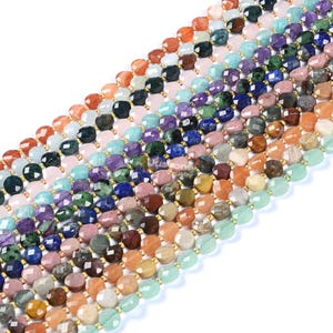 Puede incluir: Una hebra de cuentas de piedras preciosas en varios colores y formas, incluyendo verde, azul, morado, rojo y marrón. Las cuentas son facetadas y tienen un acabado pulido. La hebra está enhebrada en un cordón elástico transparente.