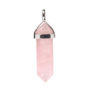 May include: A pink crystal point pendant with a silver setting. The crystal is faceted and has a pointed tip. The pendant is perfect for adding a touch of elegance to any outfit.