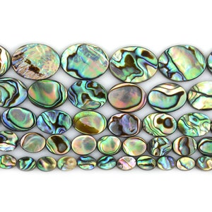 May include: A strand of oval-shaped abalone shell beads in shades of green, brown, and iridescent blue. The beads are arranged in a row, with the largest beads at the top and the smallest beads at the bottom.