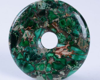 May include: A green and brown stone donut pendant with a hole in the center. The stone has a marbled pattern.