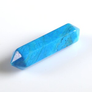 May include: A blue crystal point, also known as a crystal wand, is a smooth, polished, and pointed piece of crystal. It is a popular tool for healing and meditation.