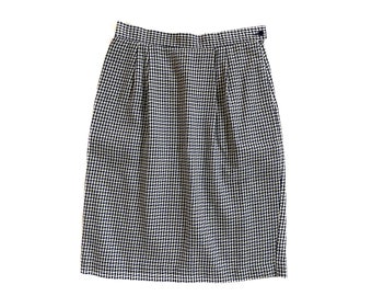 May include: A black and white gingham skirt with a button closure. The skirt is knee-length and has a straight silhouette.