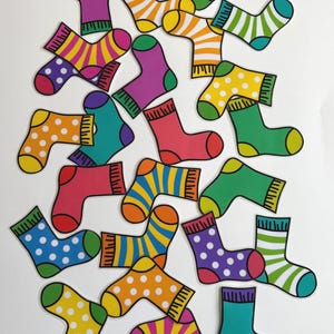May include: A collection of colorful socks in various designs, including stripes and polka dots. The socks are in shades of red, yellow, green, purple, and blue. The socks are arranged on a white background.