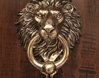 Lion Door Knocker with Ball Ring. Cast Bronze with a High Polish Finish. Appears Gold or Brass.