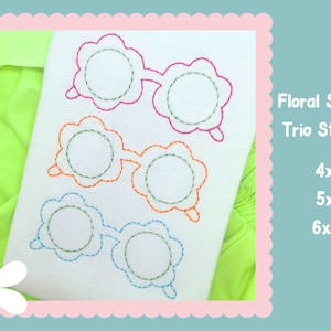 May include: Three embroidered floral sunnies stacked on top of each other in pink, orange, and blue. The embroidery is on a white fabric. The text "Floral Sunnies Trio Stacked" is on the right side of the image. Below the text are the sizes: 4x4, 5x7, and 6x10.