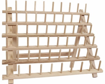 May include: A wooden thread rack with 48 pegs for holding spools of thread. The rack is made of natural wood and has a triangular shape.