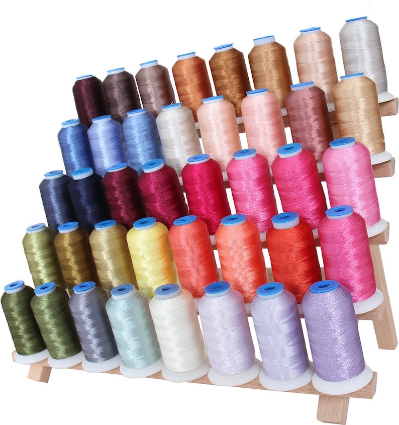 May include: A wooden thread rack with 4 tiers holding 48 spools of colorful embroidery thread. The spools are arranged in a pyramid shape and are all different colors, including pink, blue, green, yellow, orange, red, and brown.