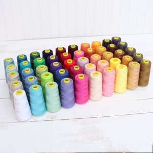 a bunch of spools of thread sitting on a table