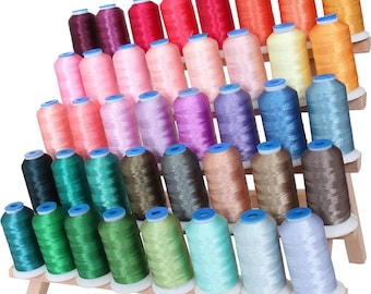May include: A wooden thread rack with multiple spools of colorful thread. The rack is tiered and holds a variety of colors, including pink, blue, green, and brown.