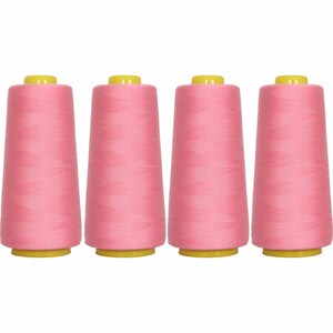 May include: Four spools of pink thread, each with a yellow plastic top.