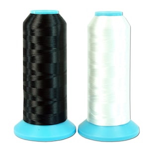 May include: Two spools of thread, one black and one white, with blue plastic bobbins.