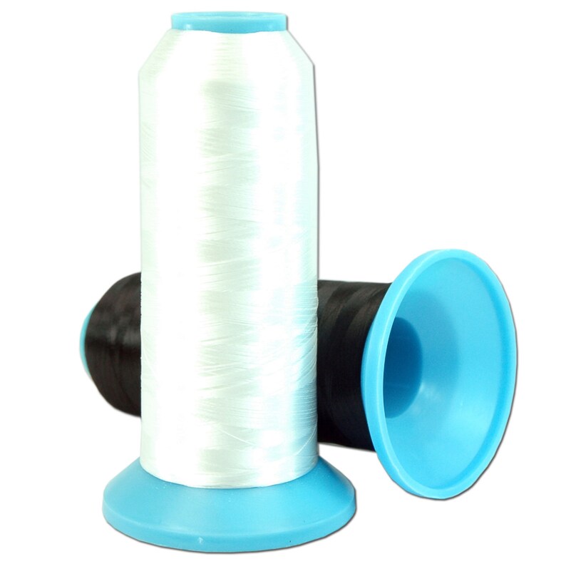 May include: Two spools of white thread with blue plastic bobbins. The thread is wound around the bobbins and is ready to be used for sewing or embroidery.