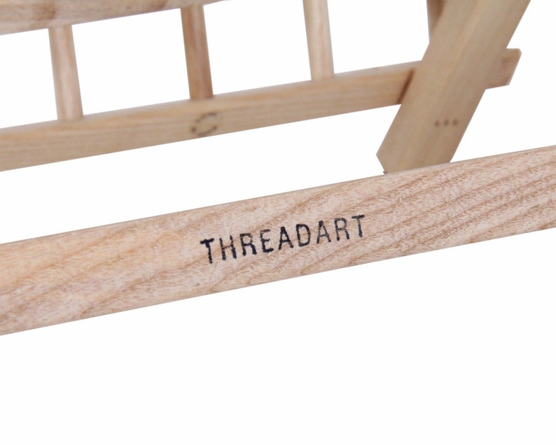 May include: A wooden thread rack with the brand name "THREADART" printed on the bottom.