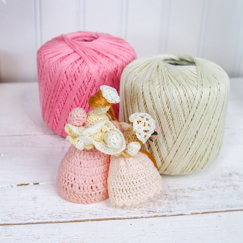 three balls of yarn sitting next to each other