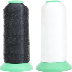 May include: Two spools of thread, one black and one white, with green plastic bases.