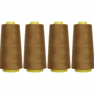 May include: Four spools of brown thread with yellow tops.