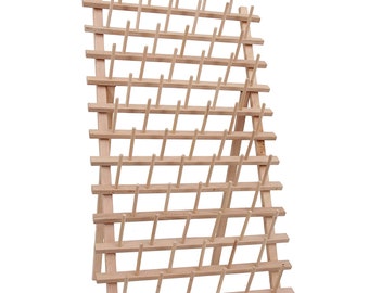May include: A wooden thread spool holder with multiple pegs for organizing spools of thread. The natural wood color and grid-like structure provide a functional and aesthetic storage solution for sewing enthusiasts.