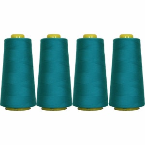 May include: Four spools of teal thread, each with a yellow plastic top and bottom.
