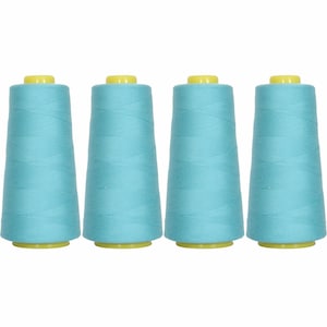 May include: Four spools of light blue thread, each with a yellow plastic top.