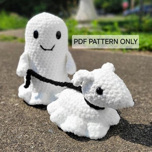 May include: A white crocheted ghost holding a black leash attached to a white crocheted dog. The ghost has a smiling face with black eyes and a black mouth. The dog has black eyes and a black nose. The image has the text "PDF PATTERN ONLY" in black letters on a white background.