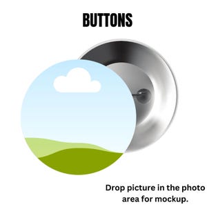 May include: A round button with a landscape design, featuring a blue sky with a white cloud and green hills. The button is partially covering a silver metal backing. The word "BUTTONS" is printed in bold black letters.