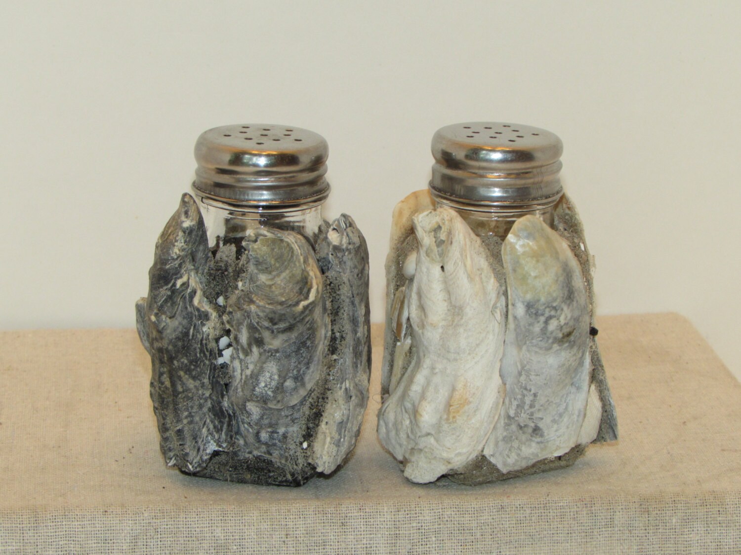 Salt and pepper shakers covered in oyster shells Etsy