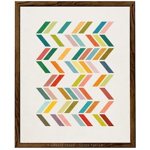 May include: A framed print with a geometric pattern of colorful chevron shapes in shades of green, blue, yellow, orange, red, pink, and brown. The print has a white background and a brown frame.