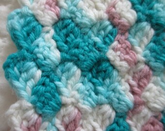 Hand crocheted  38 x 49  acrylic baby blanket in shades of aqua , teal , white , mauve and pink