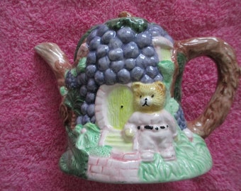 Whimsical ceramic cottage teapot with teddy bear and purple grape cluster