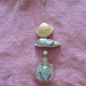 Light aqua tiny pebbles in Clear plastic  float with fishing net , sea shell ,white wood bead , driftwood
