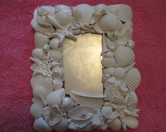 White painted sea shell mirror with pearl painted starfish , some shells and pearls
