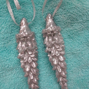 2  Vintage skinny silver painted Santa head ornaments with silver ribbon ties