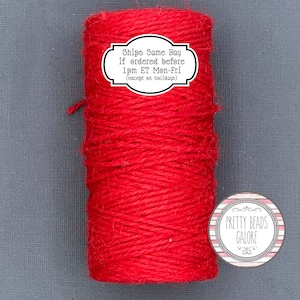 May include: A roll of red twine, with a label that reads "Ships Same Day if ordered before 1pm ET Mon-Fri (except on holidays)". The twine is wrapped around a white cardboard tube. The image also includes a logo for "Pretty Beads Galore".