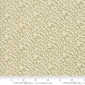 May include: Cream-colored fabric with a repeating pattern of small, olive-green berries and delicate stems. The fabric is marked with a ruler along the bottom edge, showing inch measurements. The fabric is from Moda Fabrics.