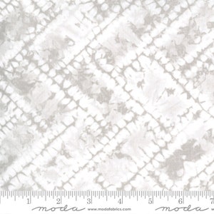 May include: A fabric with a light gray and white tie-dye pattern. The design features a grid-like structure with irregular shapes and diagonal lines. The fabric has a soft, textured appearance, suitable for quilting or apparel.