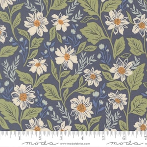 May include: A dark blue fabric featuring a repeating pattern of white daisies with yellow centers, accompanied by light green leaves and small blue floral sprigs. A white measuring tape is visible at the bottom, showing 7 inches.