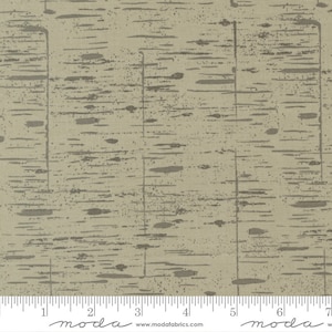 May include: A beige fabric with a subtle, textured pattern of gray lines and dots. The fabric has a slight sheen and is perfect for quilting, apparel, or home decor projects. The fabric is shown with a ruler for scale.