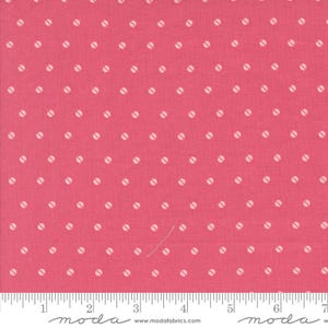 May include: A close-up of a pink fabric with a repeating pattern of white, oval-shaped dots. The dots are evenly spaced across the fabric. A ruler is at the bottom of the image, with measurements in inches.