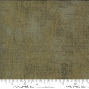 May include: A close-up of a textured fabric with a green and brown colour scheme. The fabric has a subtle sheen and a slightly rough texture. The fabric is perfect for quilting, crafts, and home decor projects.