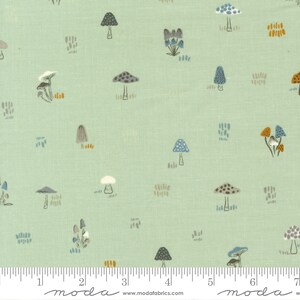 May include: A light green fabric with a repeating pattern of various mushrooms in shades of brown, gray, blue, and orange. The fabric has a subtle linen texture.