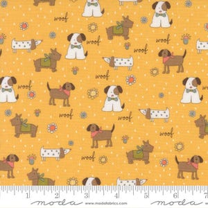 May include: Mustard yellow fabric with a repeating pattern of cartoon dogs in various poses. Some dogs wear bow ties, bandanas, or vests. The word "woof" is scattered throughout the design, along with small flowers and dots. The fabric has a ruler along the bottom.