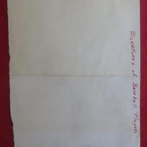 May include: A blank white sheet of paper with the words "Signatures of Baseball Players" written in red ink at the bottom right corner.