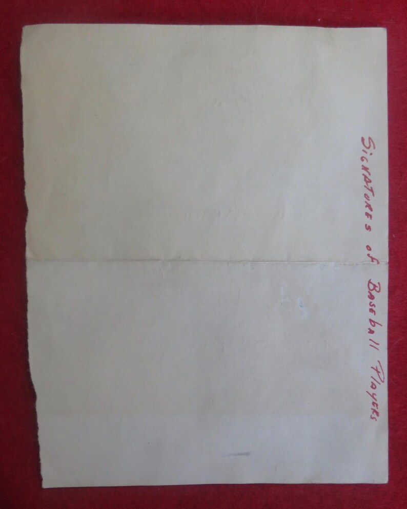 May include: A blank white sheet of paper with the words "Signatures of Baseball Players" written in red ink at the bottom right corner.