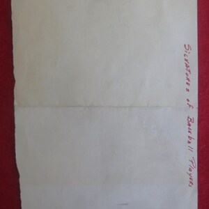 May include: A blank white sheet of paper with the text "Signatures of Baseball Players" written in red ink at the bottom right corner.
