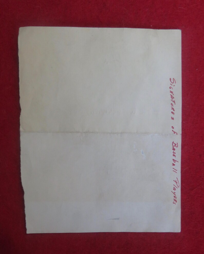 May include: A blank white sheet of paper with the text "Signatures of Baseball Players" written in red ink on the bottom right corner.