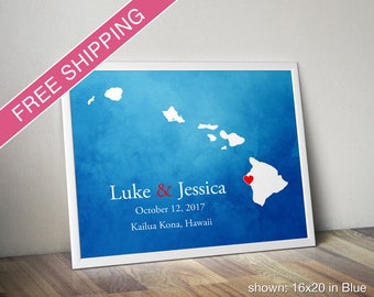 May include: A blue watercolor print of the Hawaiian islands with a red heart marking Kailua Kona, Hawaii. The print includes the text "Luke & Jessica" and "October 12, 2017".